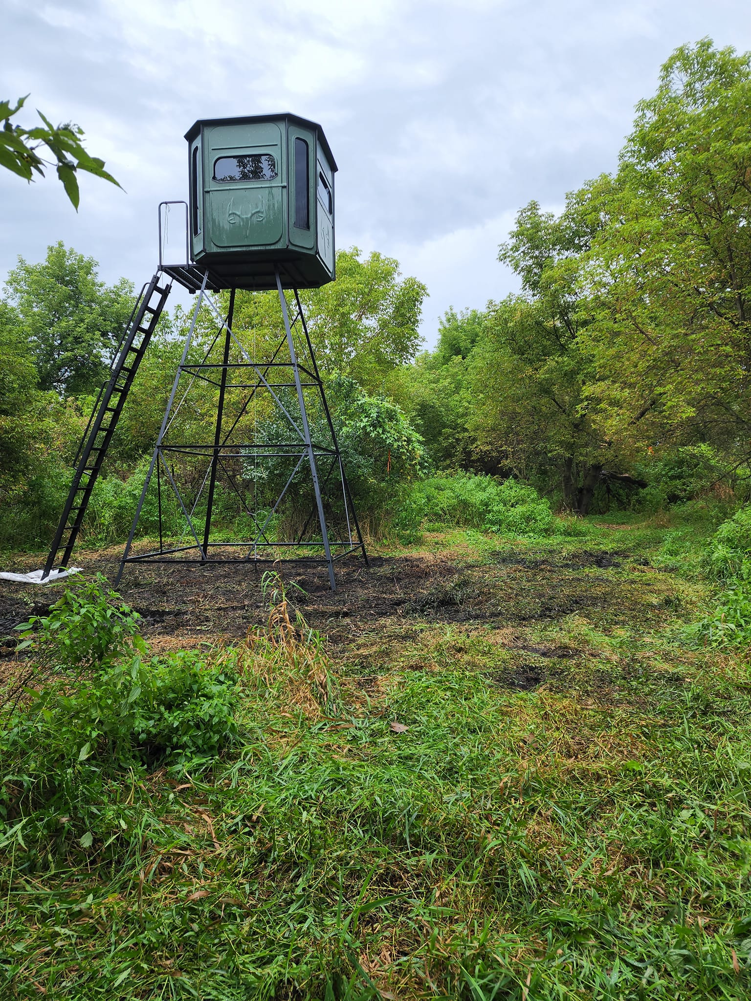 Skid steer lifting blind onto tower